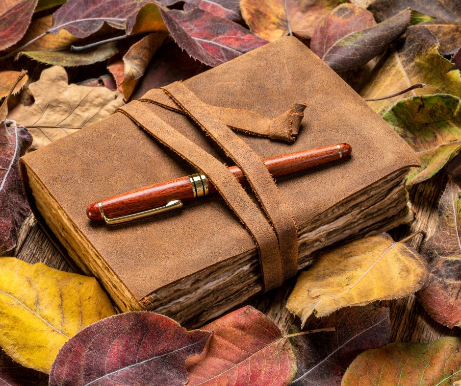 Leather Nature Journal with wooden pen in red, gold, and brown leaves